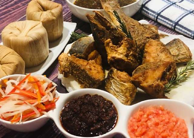 TraditionL Ghanaian Kenkey "Komi" with fried fish and hot pepper