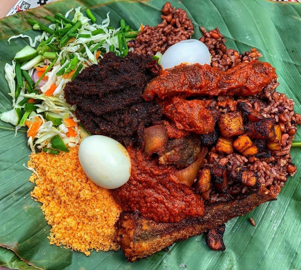 Delicious Ghanaian waakye with gari, eggs and meat